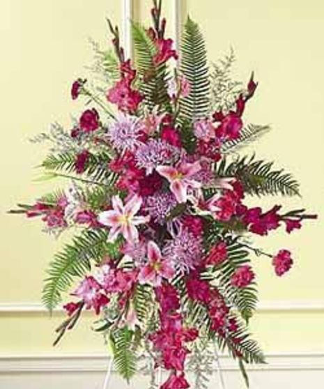 Pink and lavender Oriental Lilies, Gladioli, Mums and Sword Fern, make up this warm arrangement.