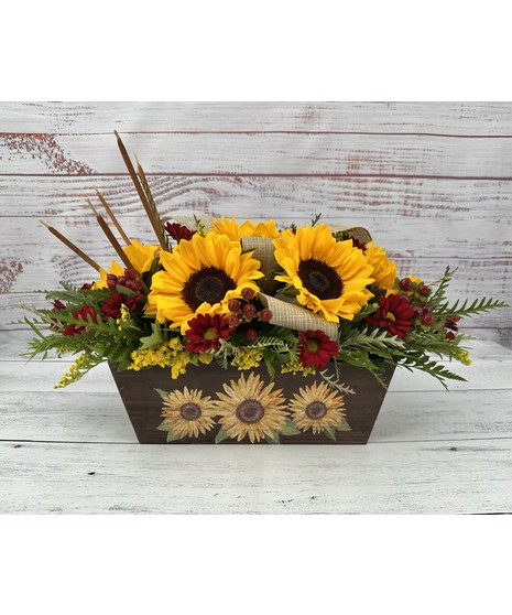 Rustic dark wood container filled with a beautiful arrangement of sunflowers, berries, fall chrysanthemums